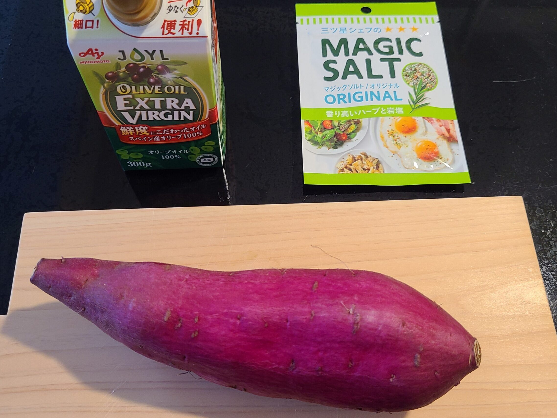 さつまいもチップスの材料を紹介している写真。テーブルにさつまいも、オリーブオイル、マジックソルトが乗っている様子
